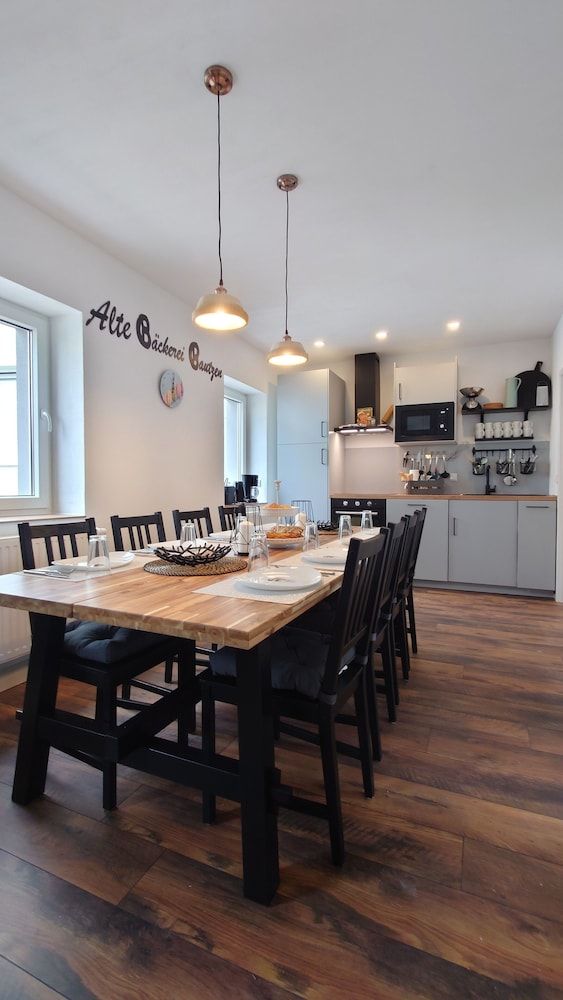 Modern Dining Area with Wood Table and Open Kitchen Design