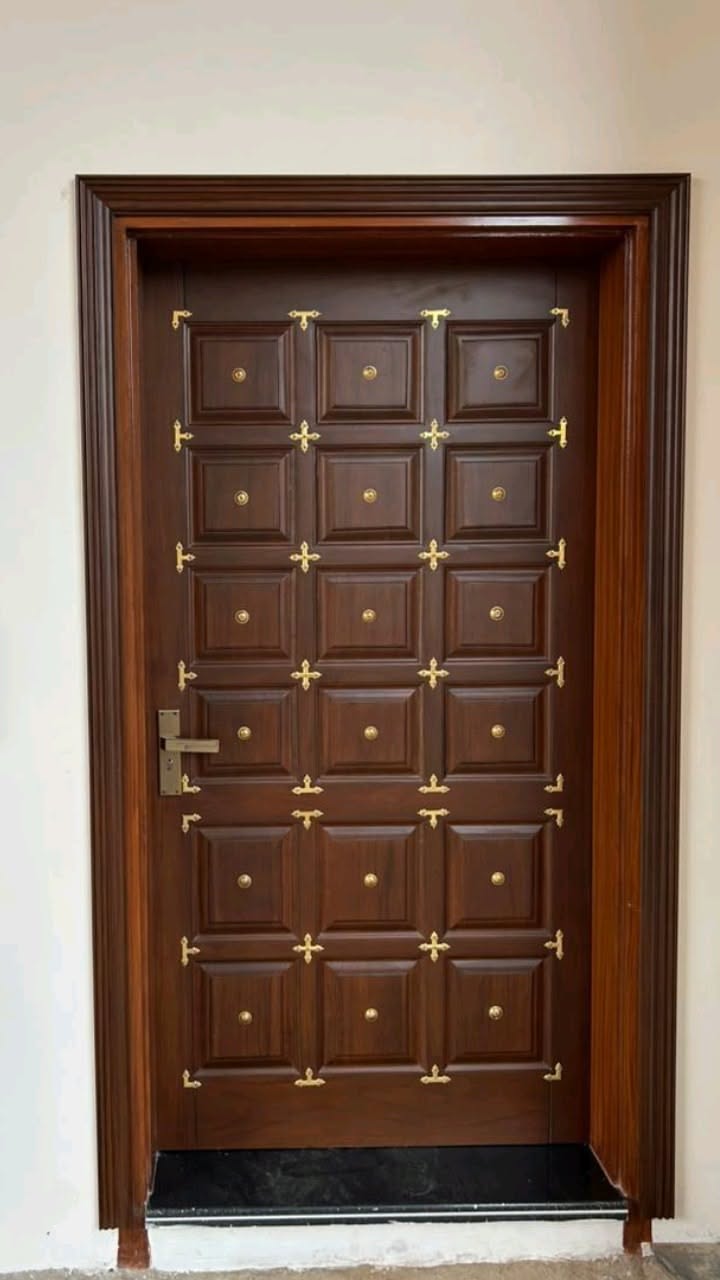 Solid Wood Entry Door with Ornate Brass Accents and Paneled Design