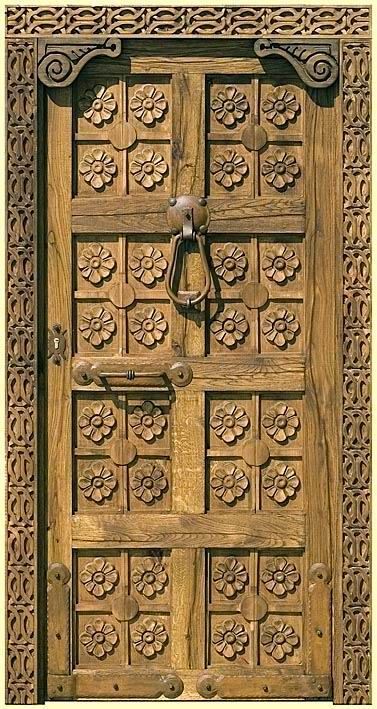 Hand-Carved Wooden Entry Door with Ornate Floral Motifs and Frame