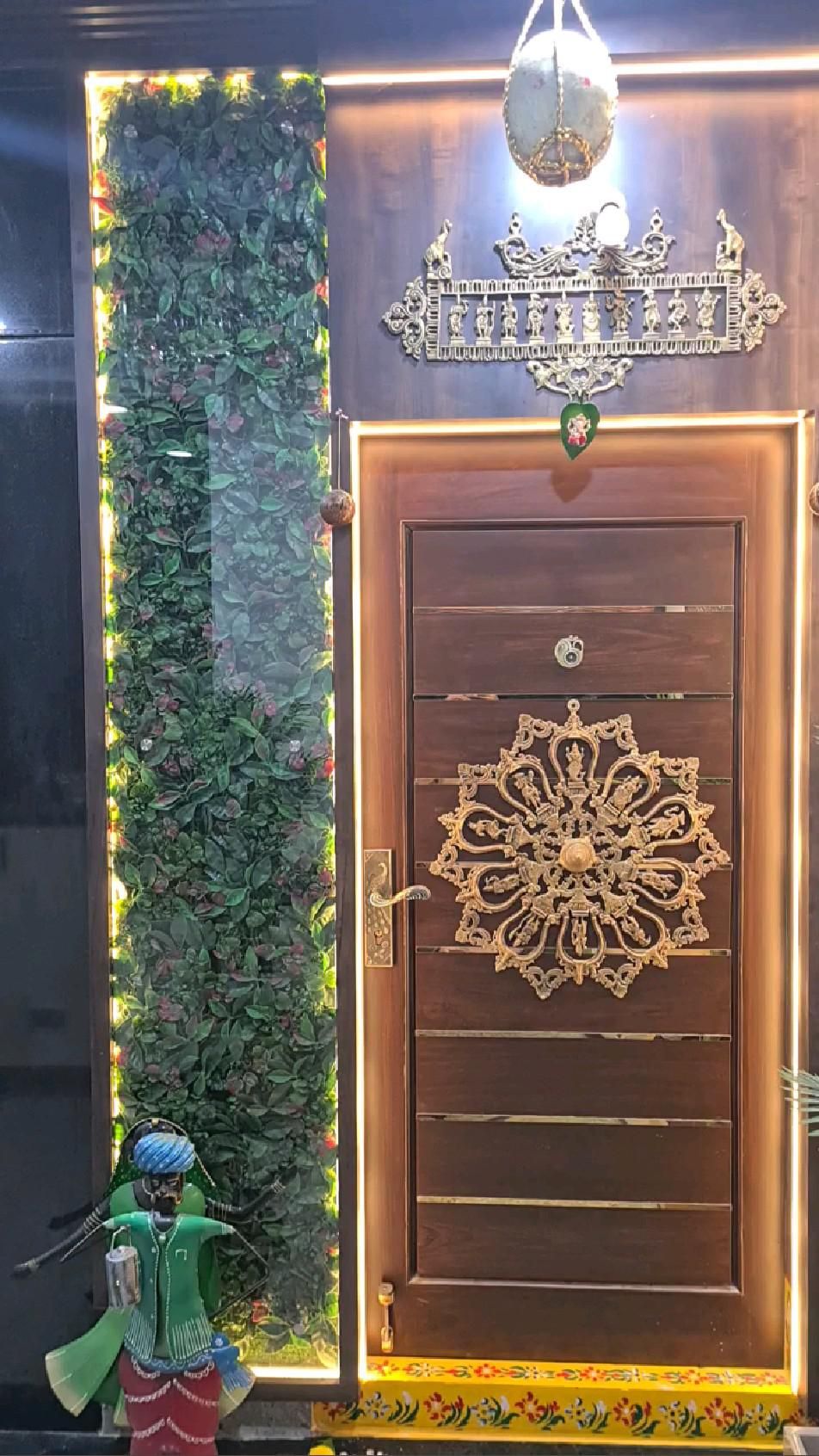 Ornate Wooden Entry Door with Gold Detailing and Vertical Garden Panel