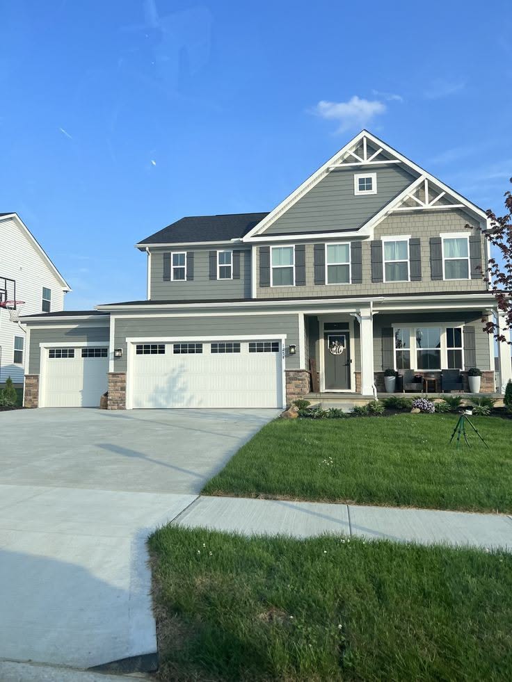 Gray Two-Story House Exterior With Three-Car Garage and Gable Roof