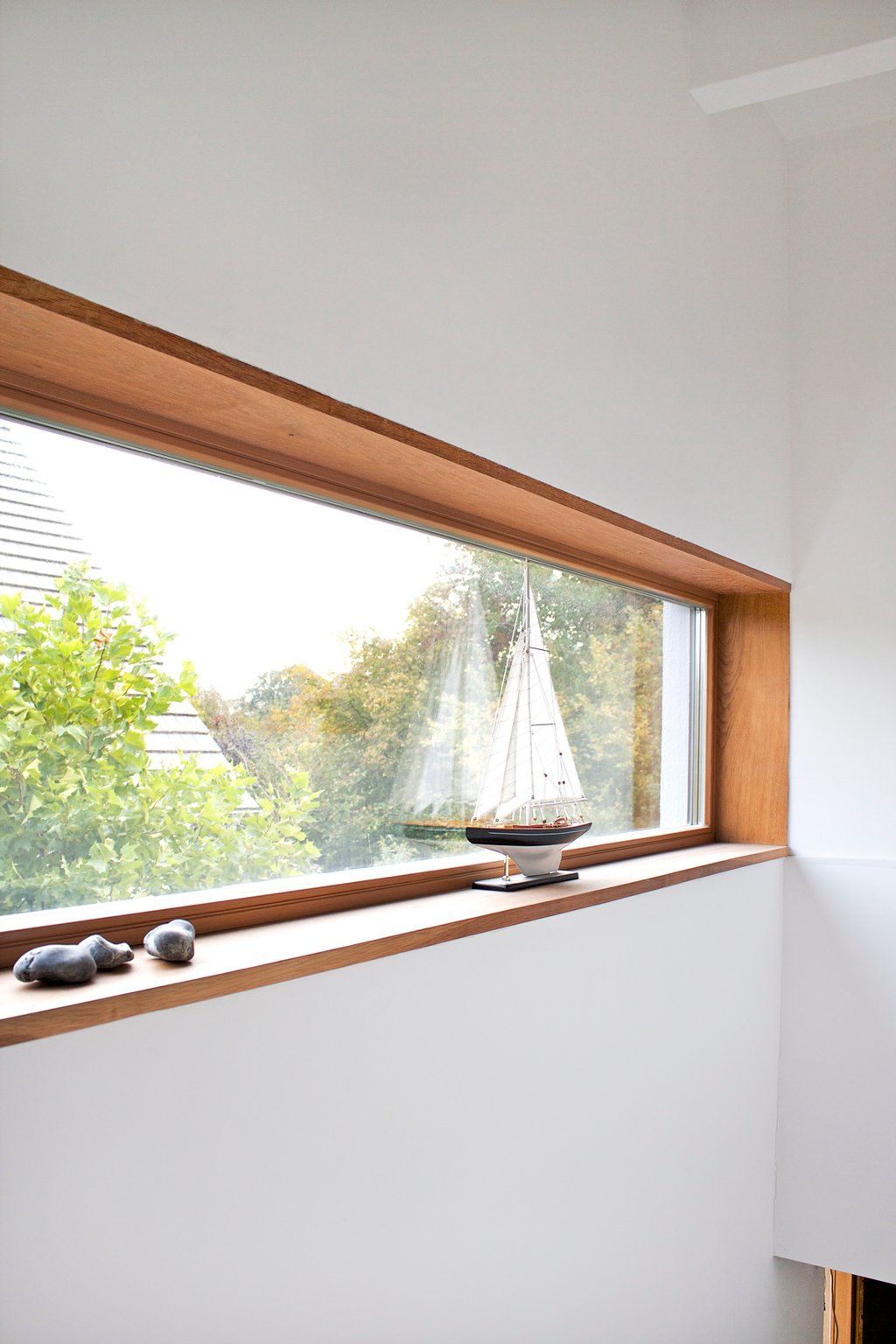 Minimalist Stairwell With Horizontal Wood-Framed Picture Window