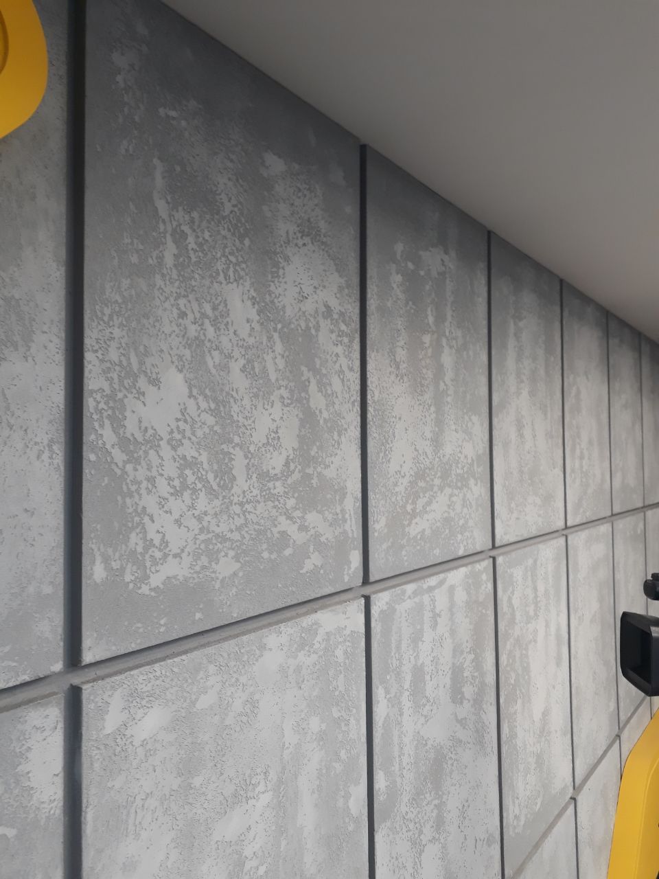 Modern Interior Wall with Large Gray Concrete Panels and Subtle Texture