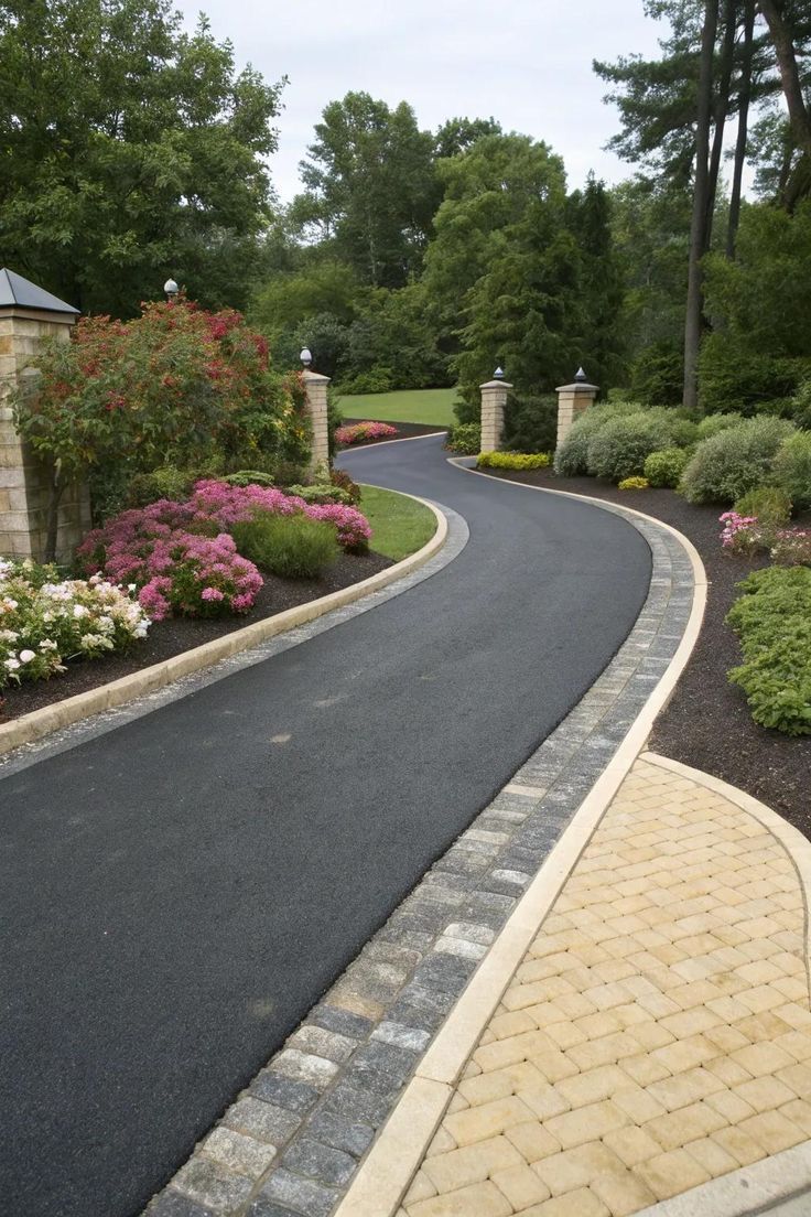 Curved Asphalt Driveway with Stone Edging and Lush Garden Borders