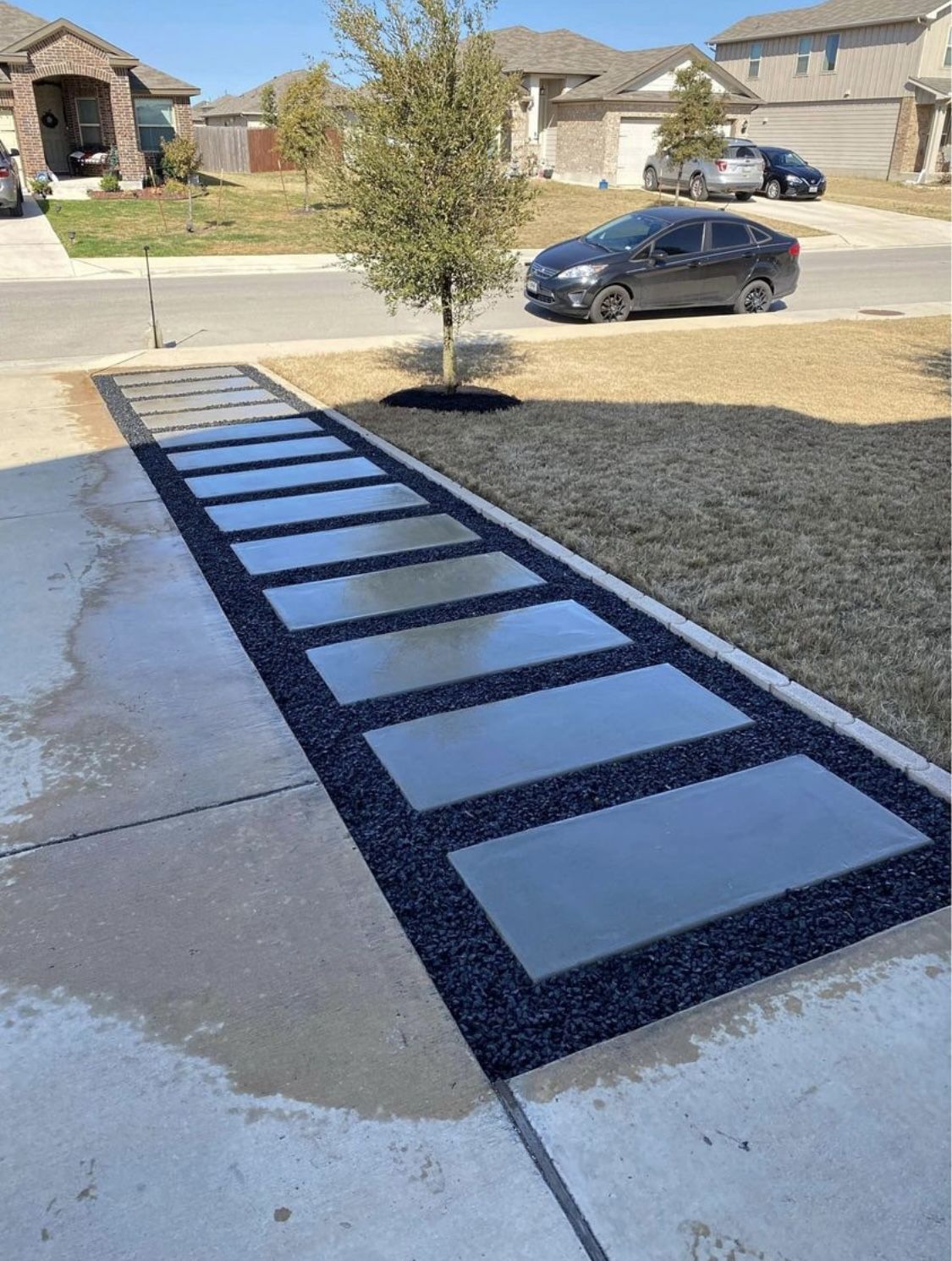 Modern Concrete Driveway with Geometric Stepping Stone Inset