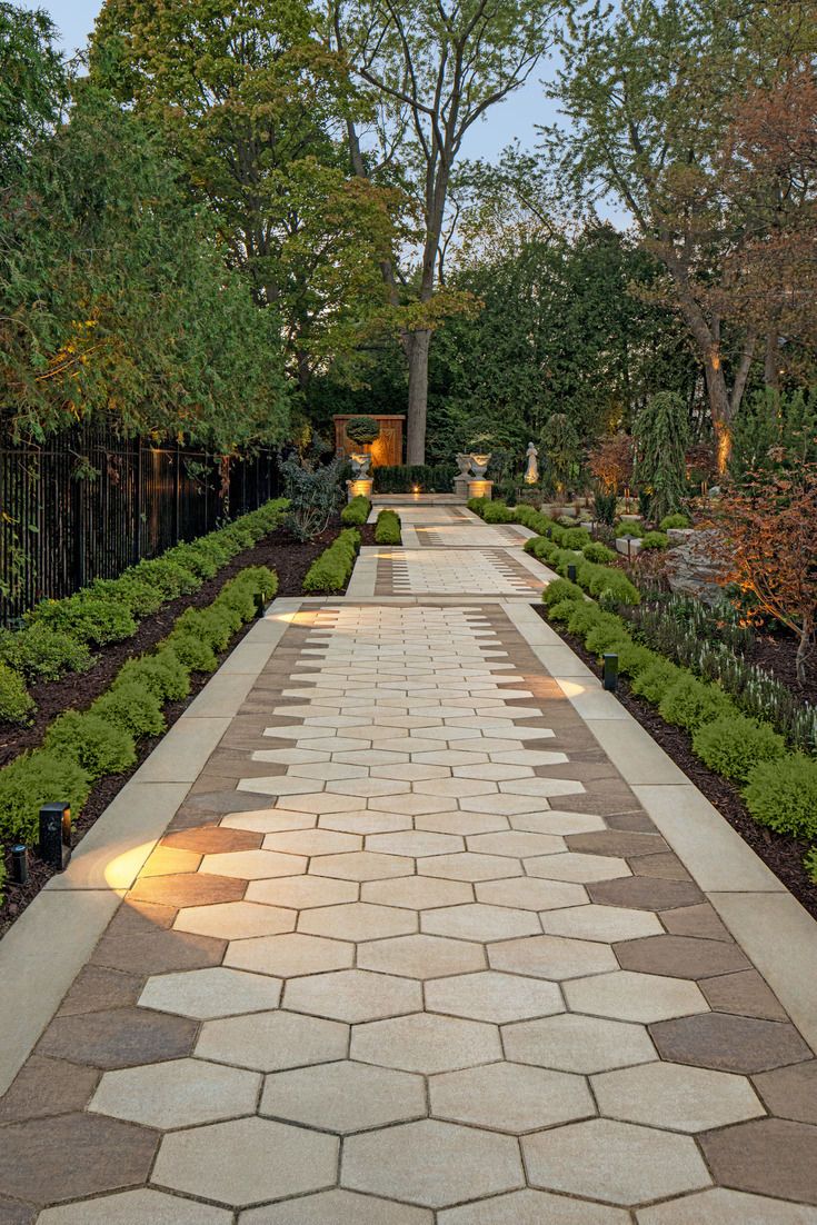 Hexagonal Paver Walkway with Garden Borders and Evening Lighting