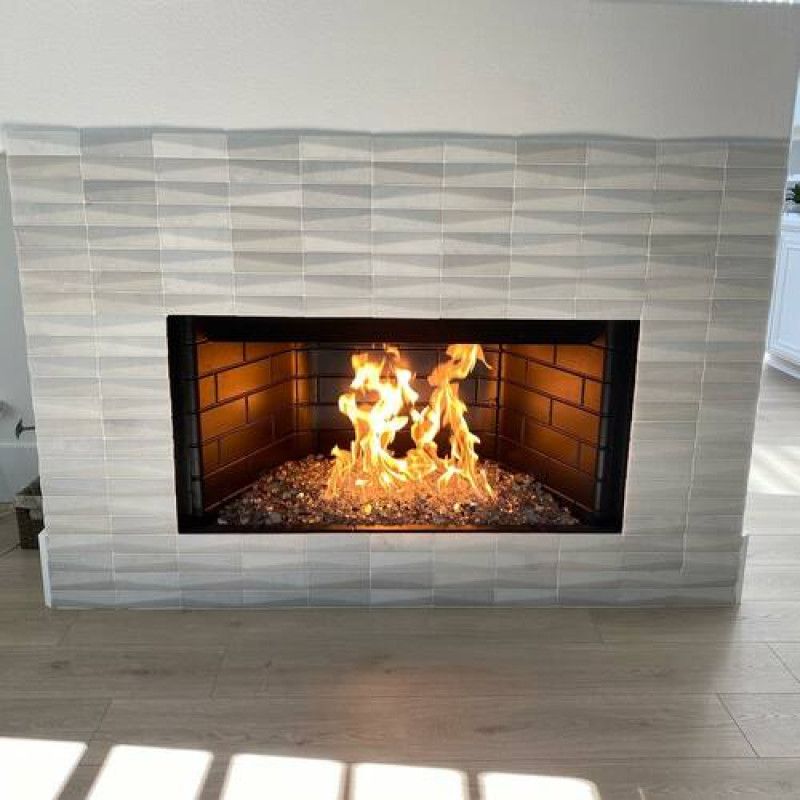 Modern Fireplace with Geometric Tile Surround and Glass Rock Bed