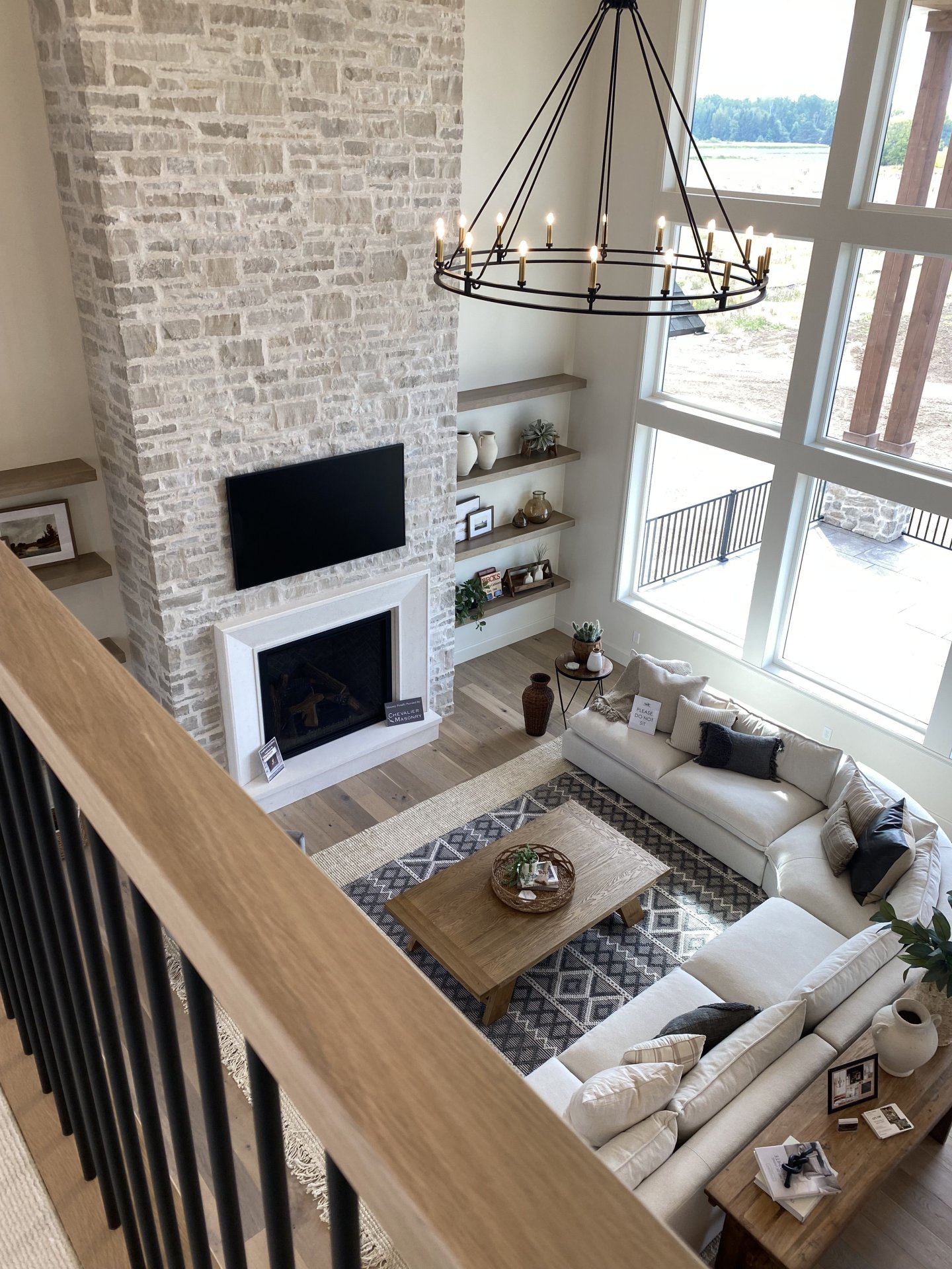 Bright Contemporary Living Room With Stone Fireplace and Vaulted Windows