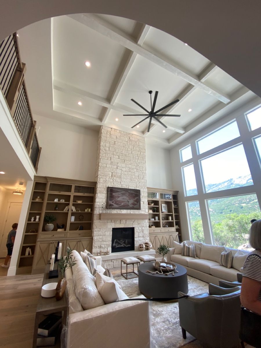 Bright Contemporary Living Room with Stone Fireplace and Tall Windows