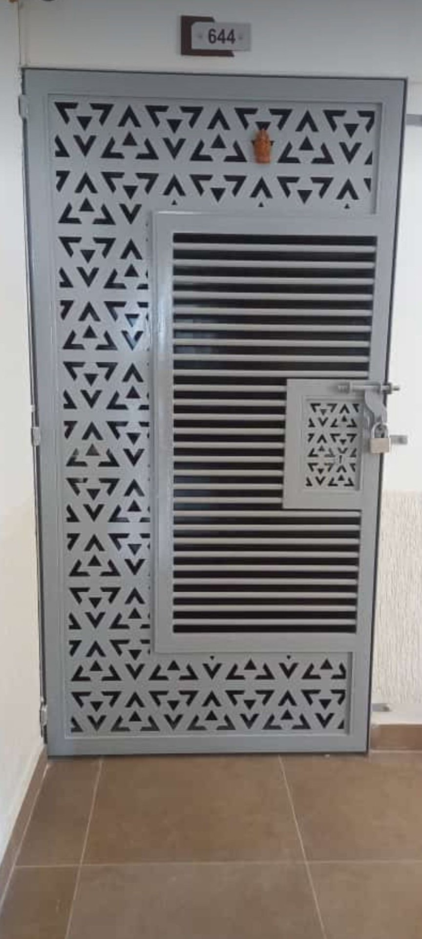 Modern Steel Security Door with Geometric Cutout Pattern for Apartment Entry